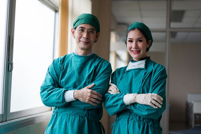 Male and female doctor in hospital scrubs after surgery