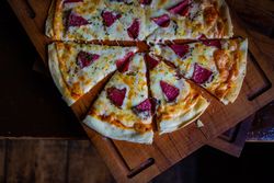 Top view of pizza with slices of meat