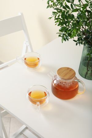 kitchen table with tea and plant