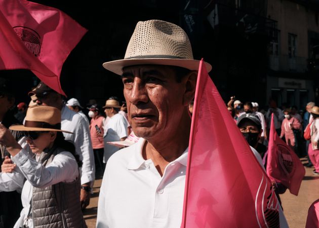 Mexico City, Mexico - February 26th, 2022: Older man in hat with pink flag joining protestors