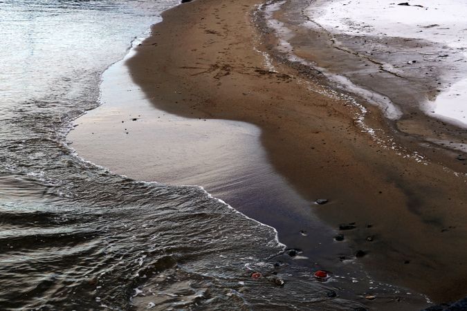 wet sandy shore on sunny day in beach
