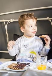 Child having breakfast in bed