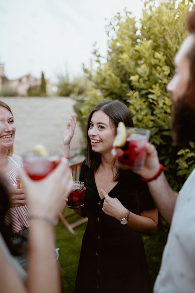Group of cheerful friends clinking glasses at party