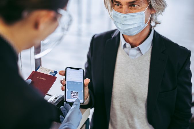 Businessman check in at airport with negative coronavirus test result