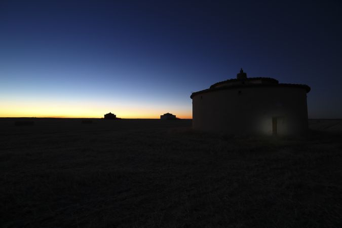 Aged house in rural countryside under starry sky
