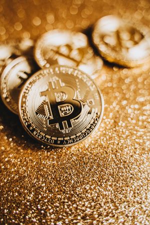 Bitcoins laid on gold surface in close-up
