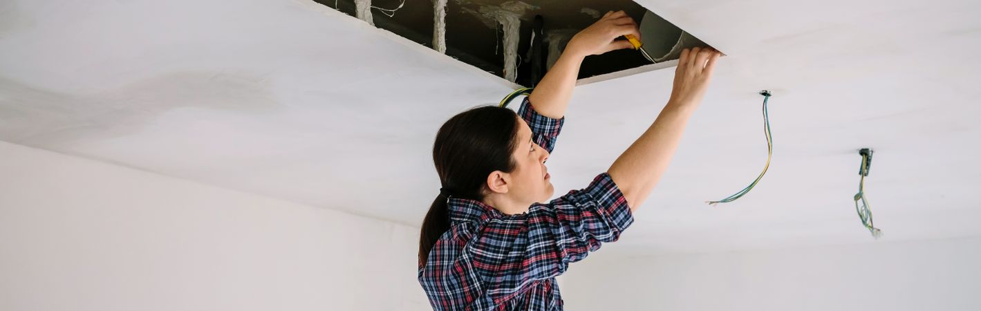 Woman preparing extractor hood installation