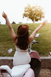 Woman spreading arms wide open to sun
