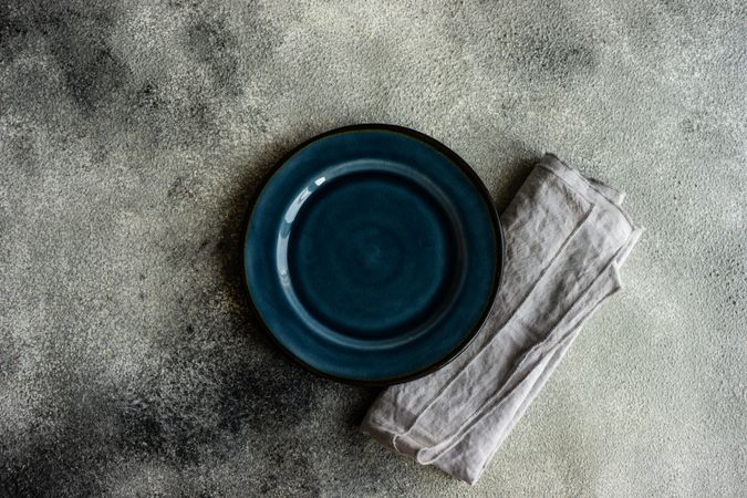 Top view of table setting with elegant dark blue plate