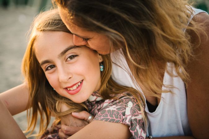 Woman with daughter on sunny beach