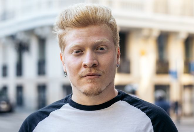 Close-up of Latino man with albinism in the city street.