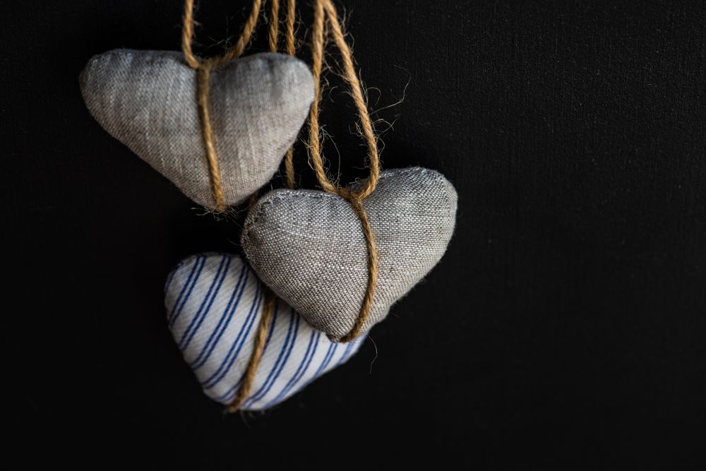 Felt heart decorations on dark background