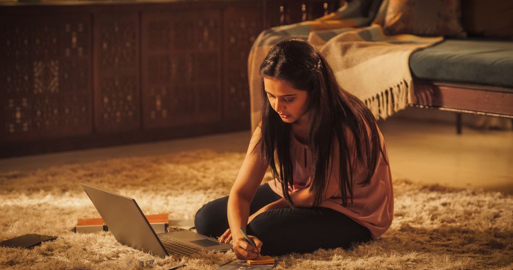 Diligent Indian Woman Studying at Home: Focused on Online Course, Gaining Knowledge for Higher Education.