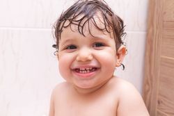 Funny baby in towel after shower