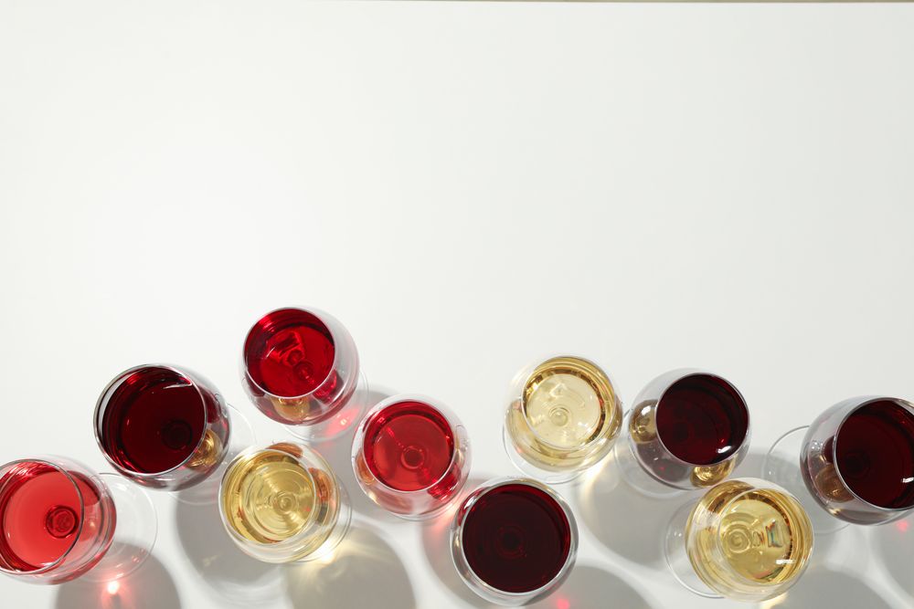 Flat lay composition. Glasses with different wine on plain background, top view