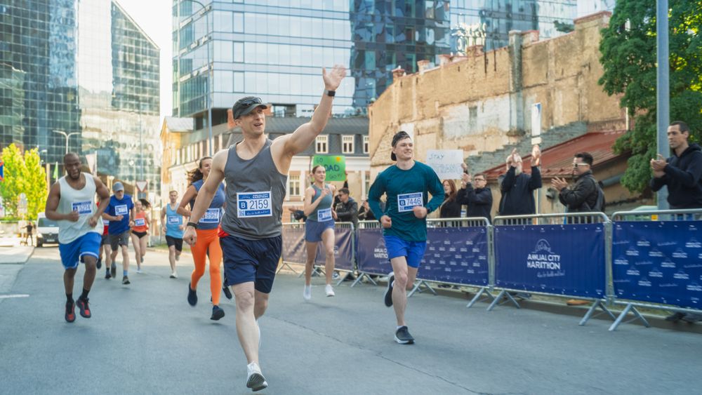 Friendly Happy Male Runner Celebrating Crossing the Finish Line in a Race