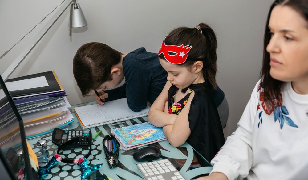 Woman teleworking with her son and angry daughter