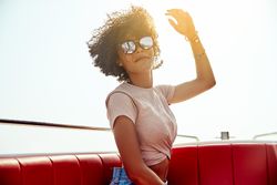 Woman in sunglasses posing on boat