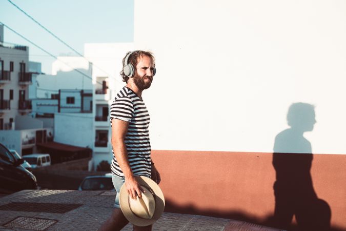 Young male walking with mobile phone