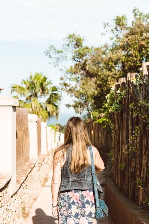 Woman walking in a narrow path