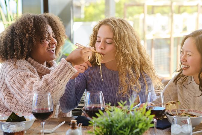 Cheerful diverse women hanging out in restaurant