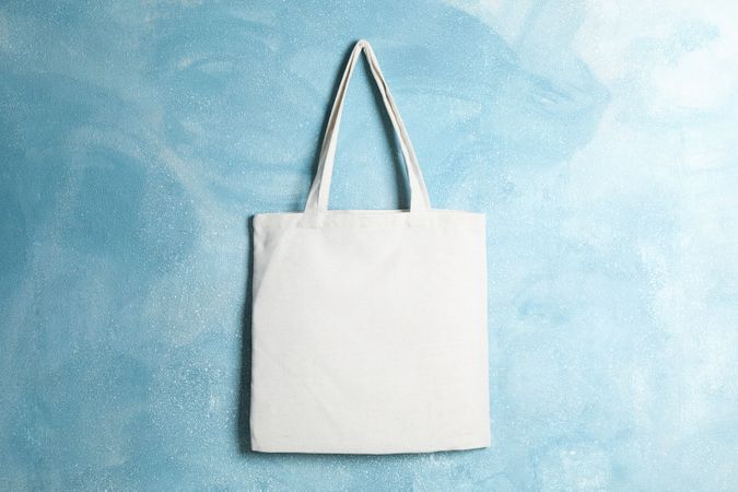 Tote cotton bag on color wall, space for text