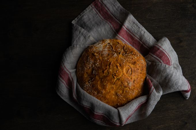 Homemade bread boulle in kitchen towel