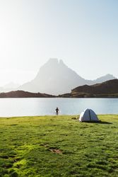 Man bathing near the tent in the mountain
