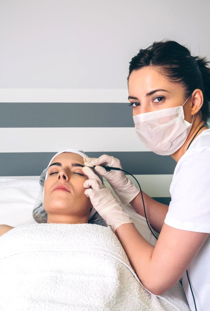 Portrait of woman receiving treatment from beautician in clinical center