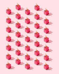 Many red presents over pink background