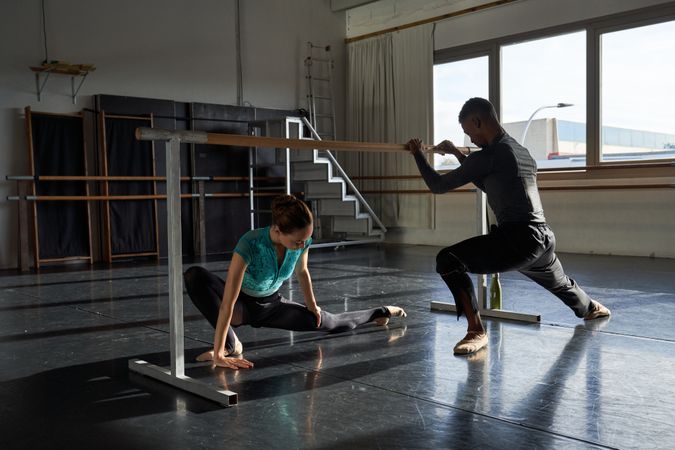 Couple of dancers in a class doing a training in ballet academy