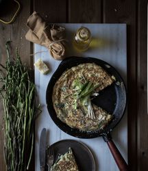 Tortilla with fresh green in skillet pan