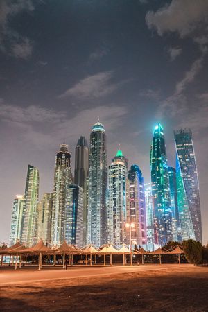 Cloudy sky over illuminated metropolis