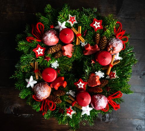 Christmas wreath with cinnamon sticks and red ornaments