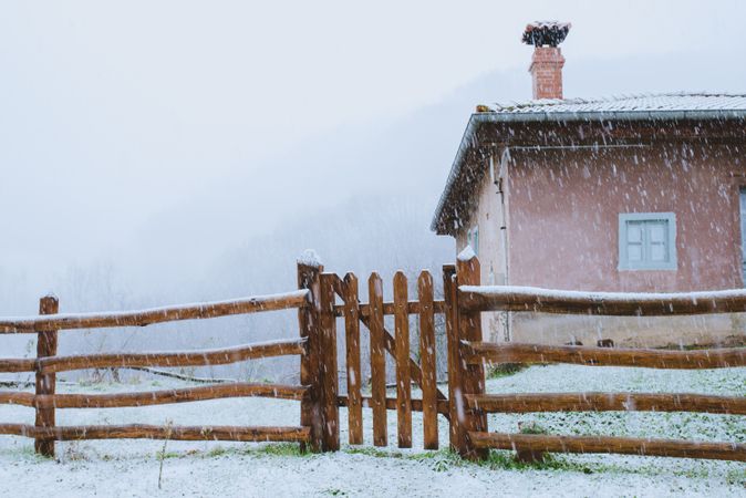 Old building and wooden fence in winter