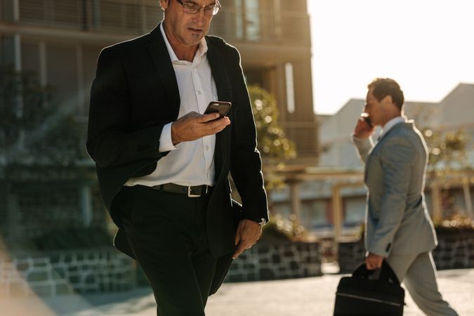 Men using mobile phone while commuting to office