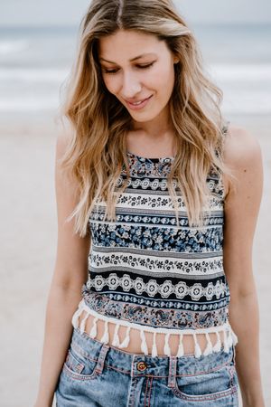 Happy female laughing on sandy beach