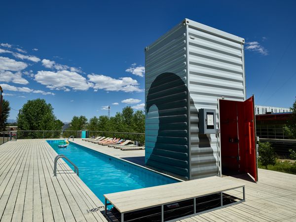 Narrow rooftop pool made of shipping containers