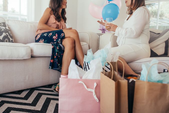 Pregnant woman talking with friend at baby shower