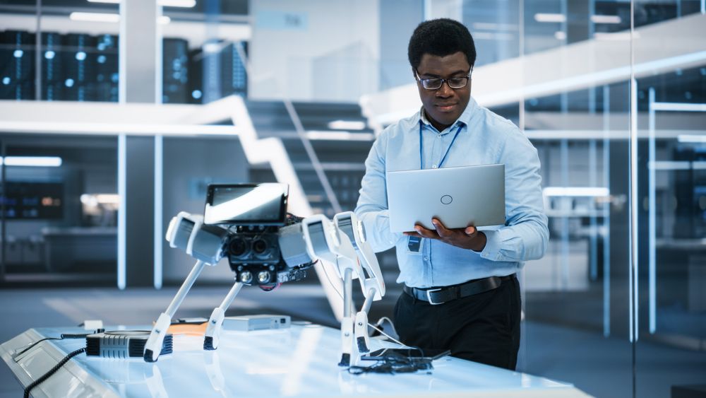 Young Intelligent Male Engineer or Scientist Working in Laboratory.