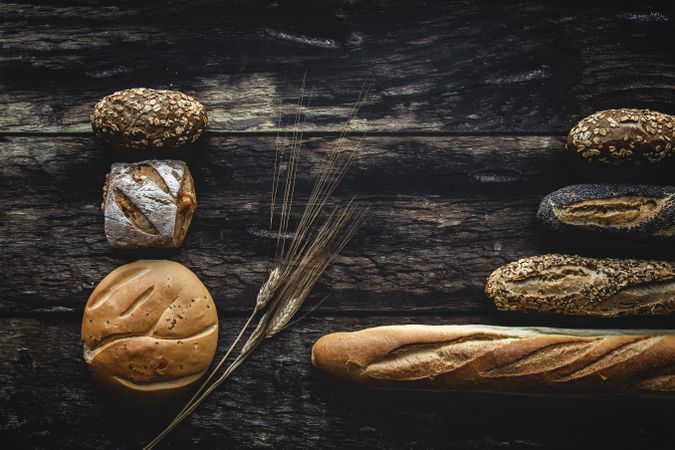 Assorted gold homemade bread on dark wood background