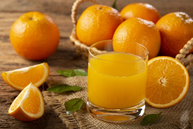 Glass with orange juice on the table.