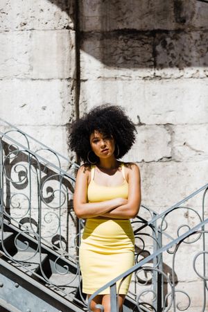 Stylish Black female leaning on railing outdoors