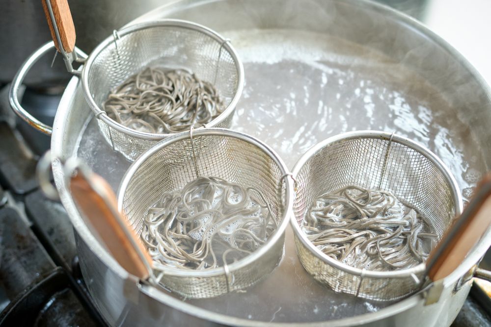 Process of cooking noodles in saucepan with boiling water