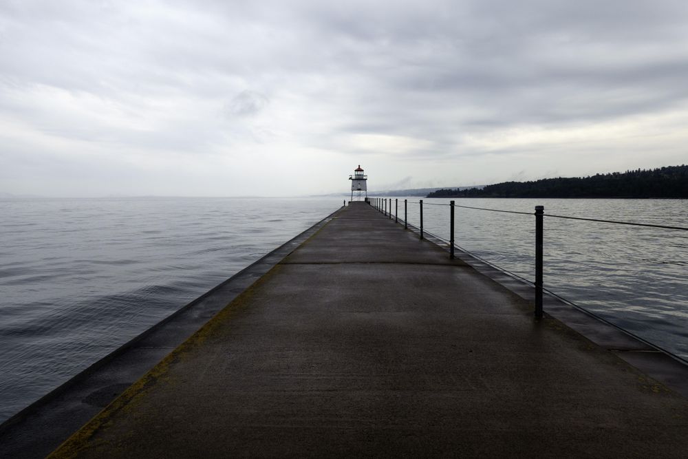 Shot of Two Harbors Light House with forest and clouds in the background