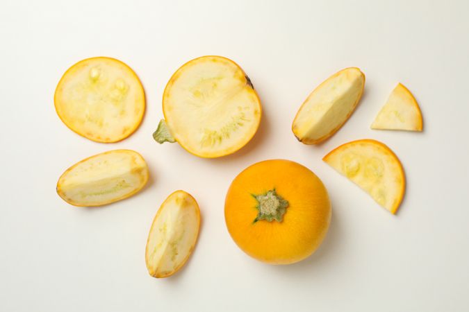 Round zucchini and slices on neutral background, top view