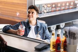 Male customer of food truck picking up two fresh juices