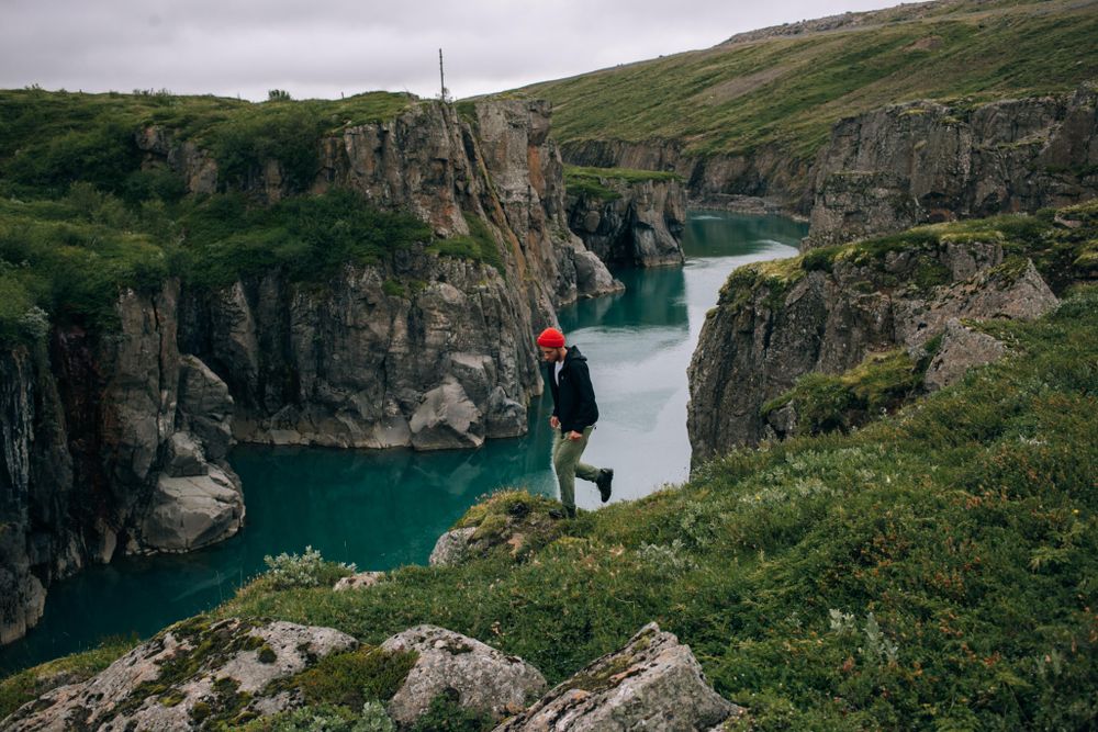 Man walking on cliff over water