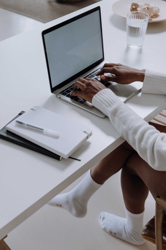 Person using a computer wearing socks at home