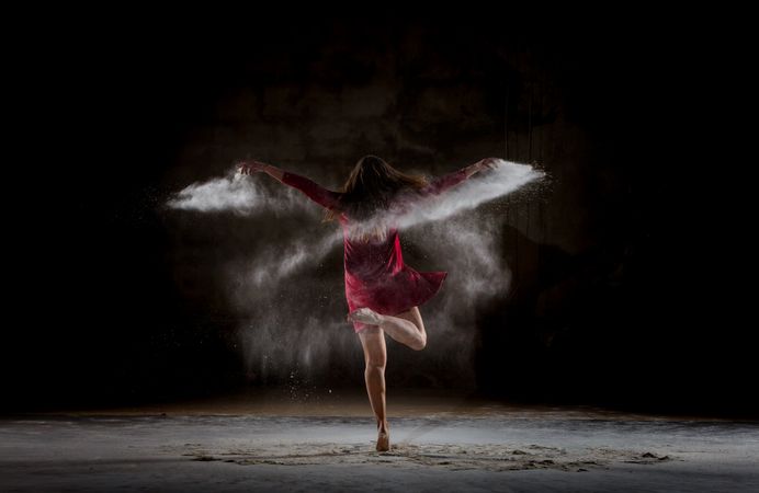 Young woman between fog in darkness